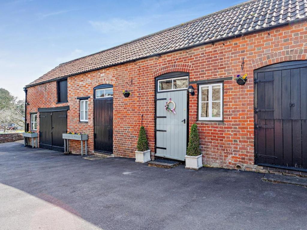a brick building with two doors and two gates at 2 Bed in Malmesbury oc-91453 in Malmesbury