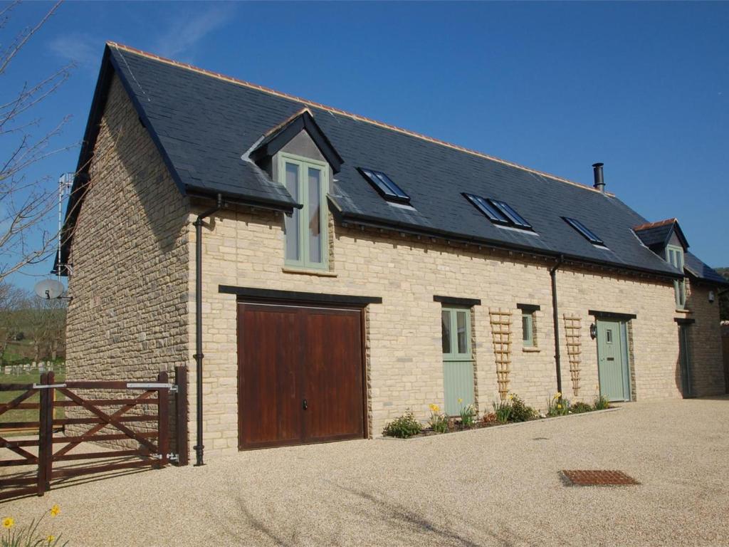a brick house with a wooden garage at 3 Bed in Wareham oc-dc137 in West Lulworth