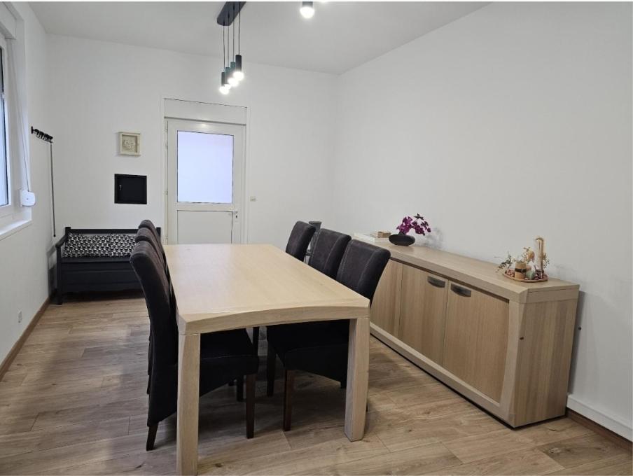 a dining room with a table and chairs at Villa chez Fred in Le Quesnoy