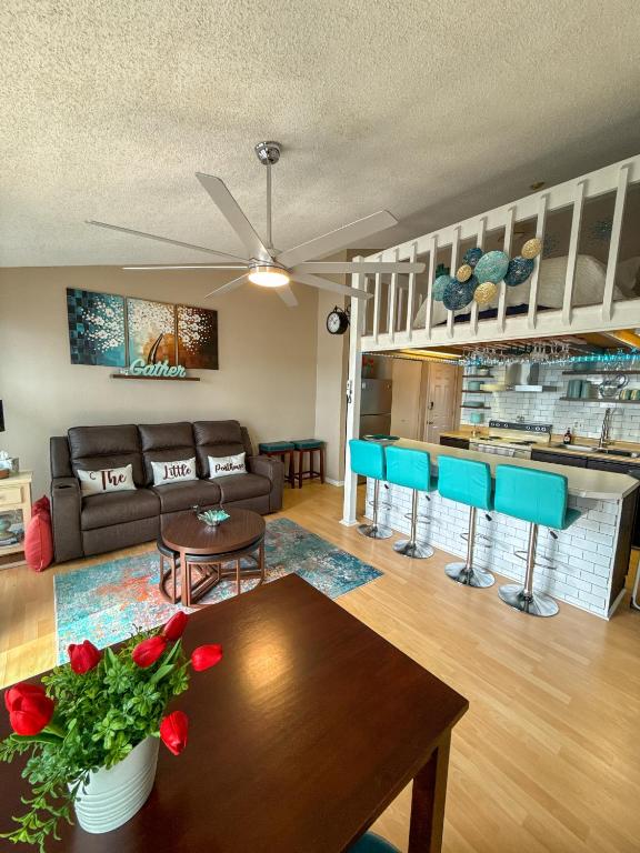 a living room with a couch and a table at The Little Penthouse in Lake Ozark
