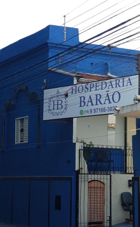 a blue building with a sign for a barrio at Hospedaria Barão in Campinas