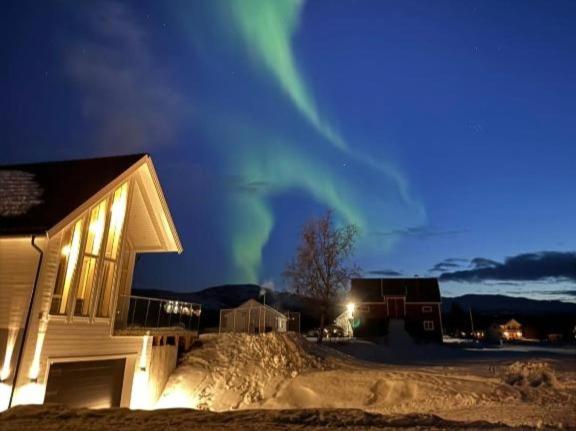 a house with the aurora in the sky at night at Villa Aurora in Alta