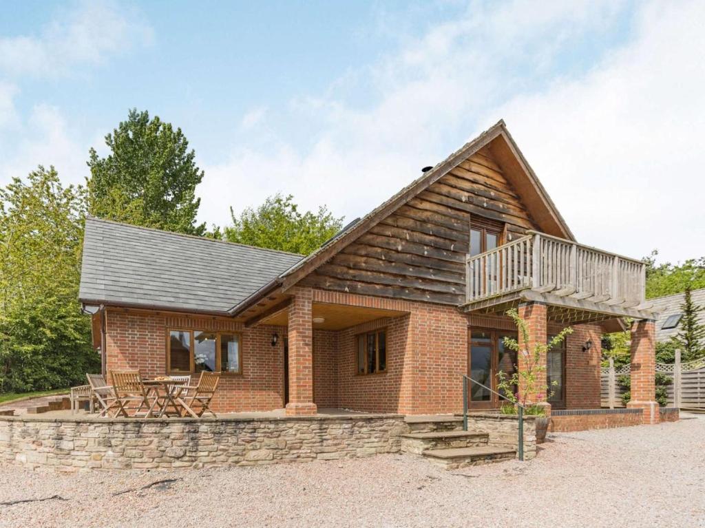 a brick house with a balcony and a deck at 4 Bed in Worcester oc-77991 in Clifton upon Teme