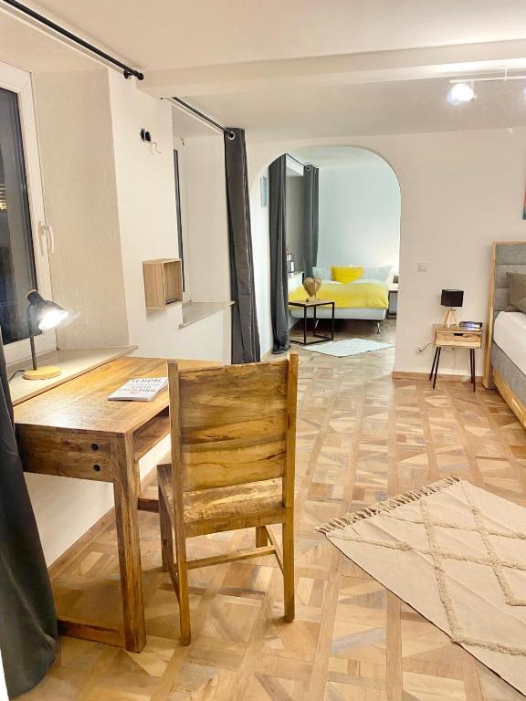 a living room with a table and a yellow couch at Ferienwohnung Kleinôd Sayn in Bendorf