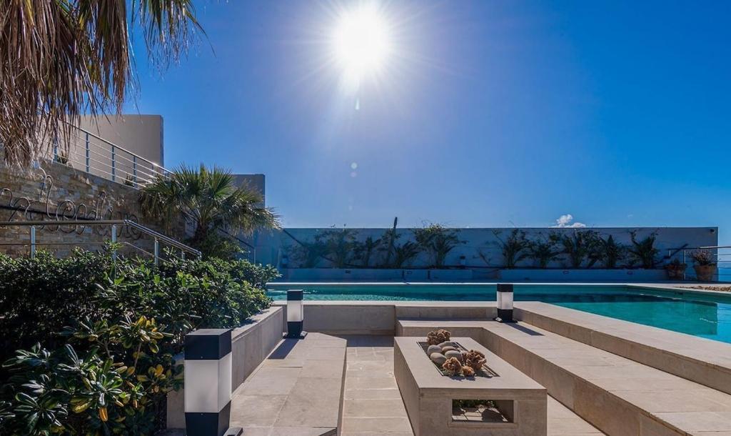 a swimming pool with a bench next to a swimming pool at Borderline in Al Matlīn