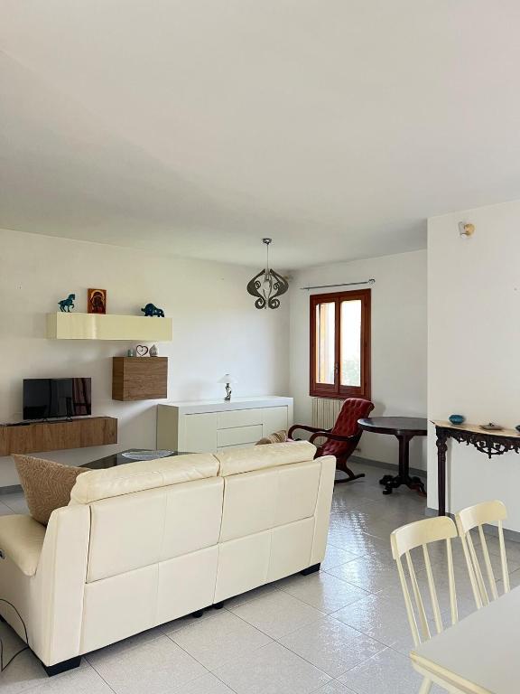 a living room with a white couch and a table at Dimora Maffi in Metaponto