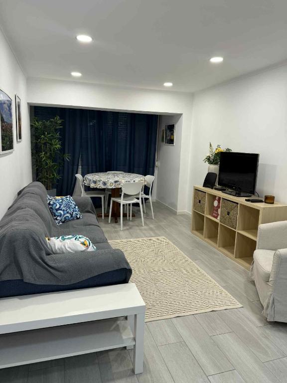 a living room with a bed and a dining room at Chinde Guesthouse in Lisbon