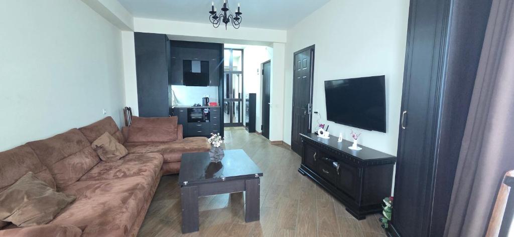 a living room with a couch and a table at Cozy Corner in Tbilisi City