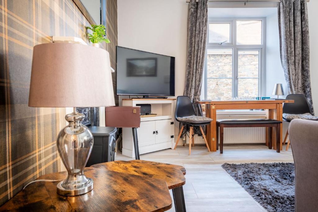 a living room with a lamp on a table at Wanderer's Rest in Lynton