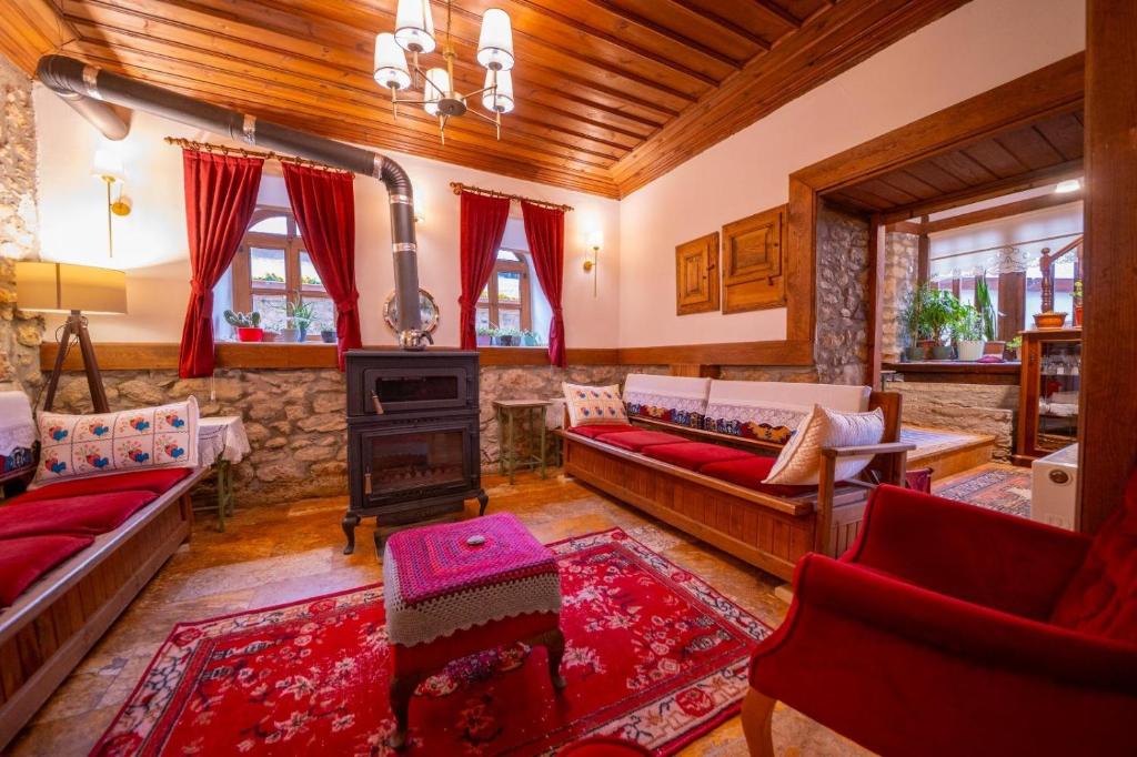 a living room with couches and a stove at Birol Sengun Bag Evi in Safranbolu