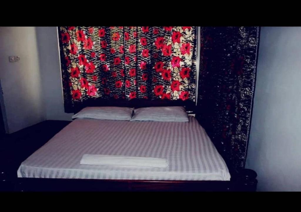 a bed with a headboard with a blanket on it at Explore Rock city Mwanza in Mahango