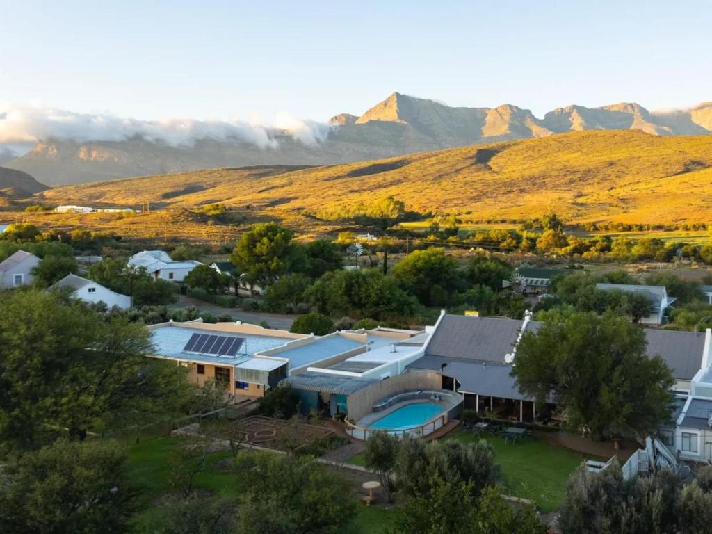 an aerial view of a home with mountains in the background at Klaarstroom Hotel in Klaarstroom
