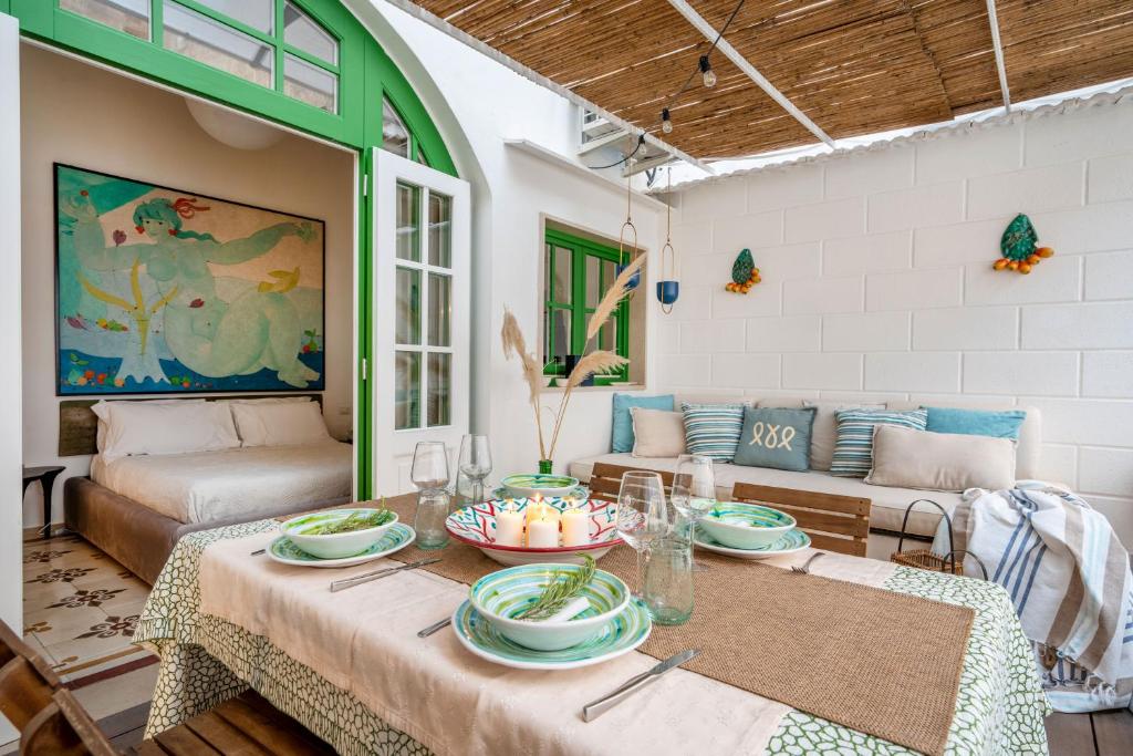 a living room with a table with plates on it at Dimora Sardaro Suites by BarbarHouse in Monopoli
