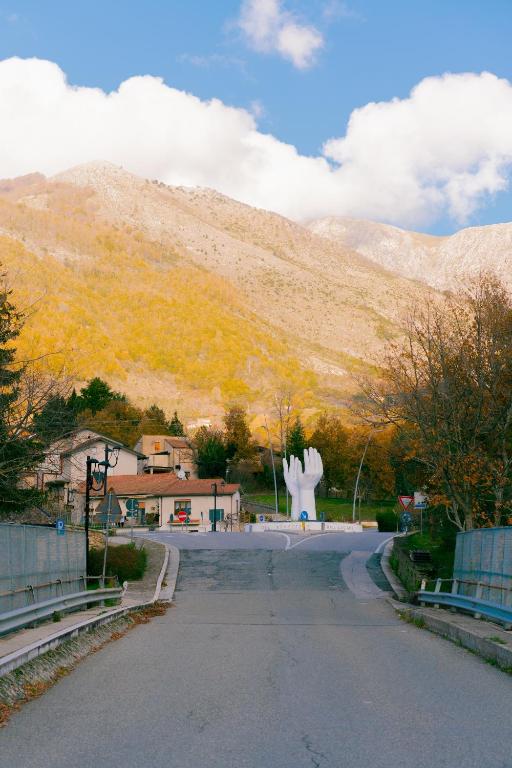 a road with a statue in the middle of a mountain at Il Sogno B&B Latronico Terme e Parco del Pollino in Latronico