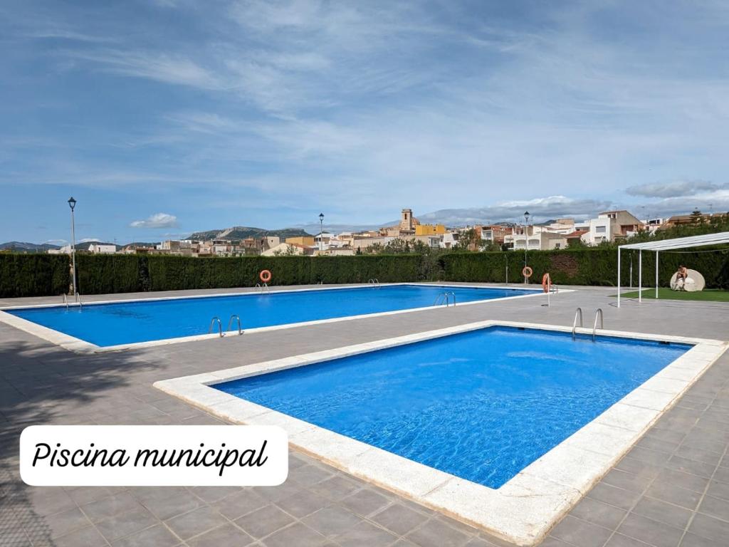 a large swimming pool with blue water at Casa rural- Casa Liberta in Canet lo Roig