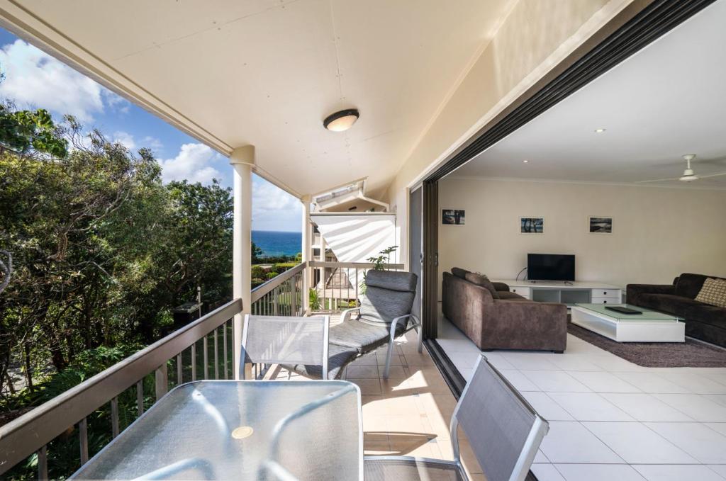 a living room filled with furniture and a balcony at Sunseeker Holiday Apartments in Sunshine Beach