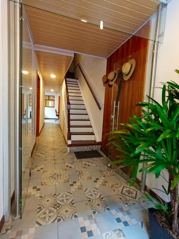 a hallway with a staircase and a tile floor at Casa San Andres Hostal in Pasto