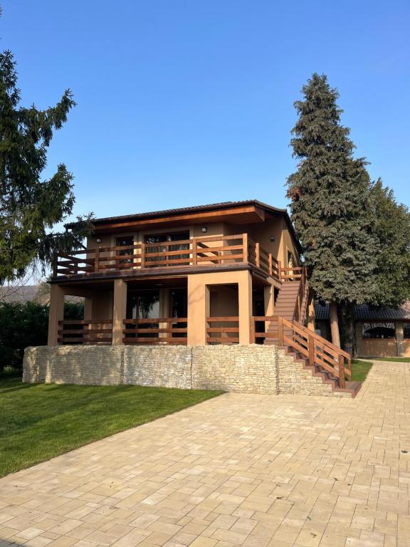 a large house with a stone wall in front of it at Carp Land Camp in Balatonszepezd