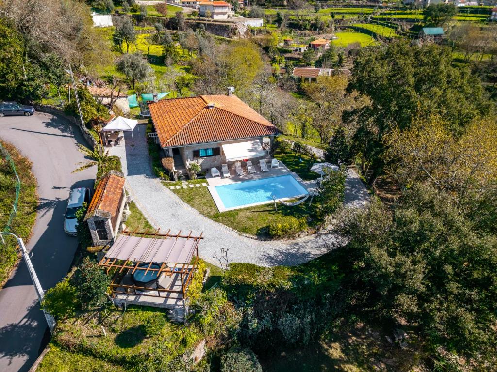 an aerial view of a house with a swimming pool at Casa Sejões Gêres - by Proguest in Terras de Bouro