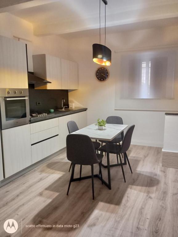a kitchen and dining room with a table and chairs at Irisapartment in Reggio di Calabria