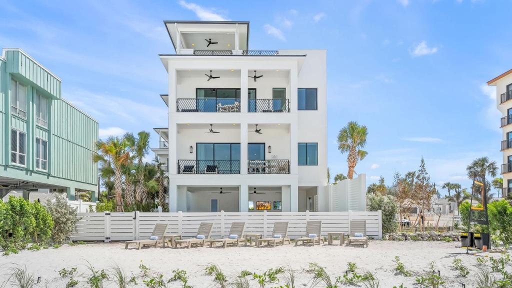 a white building with chairs in front of it at The Pearl in Clearwater Beach