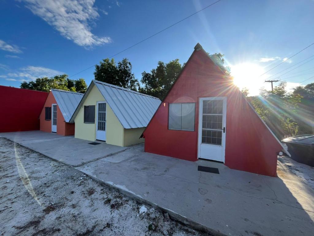 a row of houses with the sun shining behind them at Condomíno dos Chalés in Porto Seguro