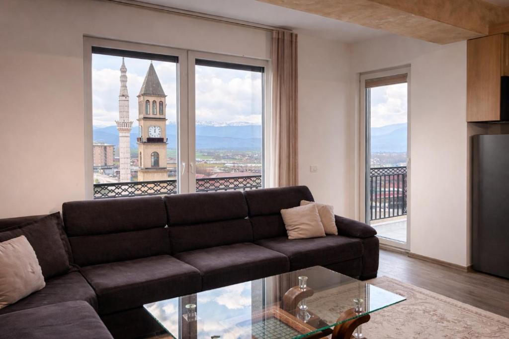 a living room with a couch and a large window at Dialb Apartments in Debar