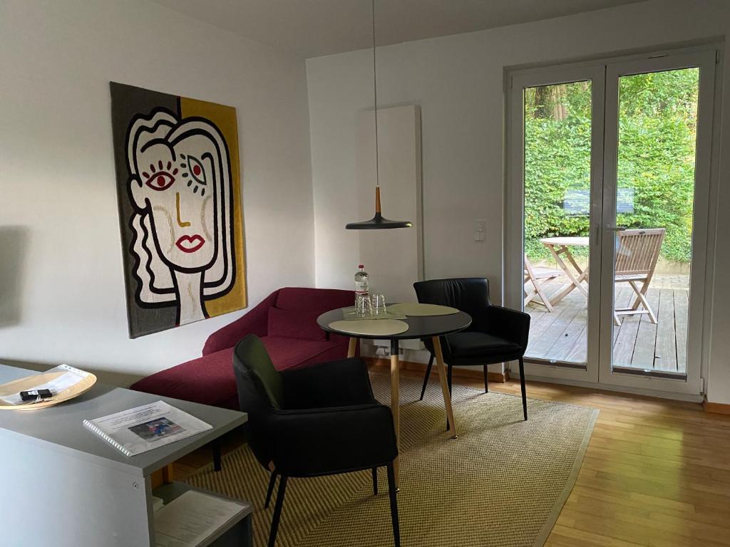 a living room with a couch and a table at Saunahäuschen in Schmilau