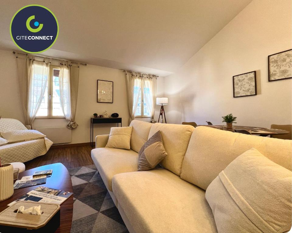 a living room with a couch and a table at ROUERGAT's LITTLE GITE in Villefranche-de-Rouergue