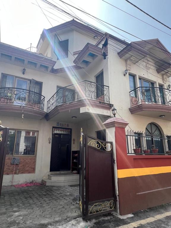 a white house with a door in front of it at Konjyosom Homestay-Experience Real Nepali Hospitality in Kathmandu