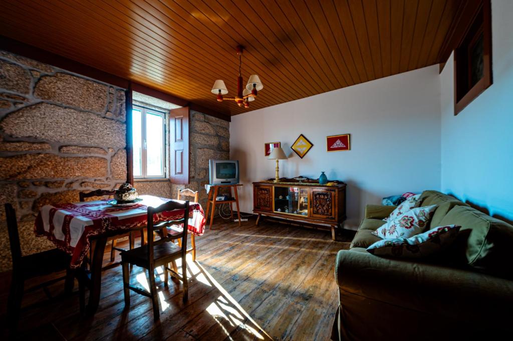 a living room with a table and a couch at Casa do Miradouro in Guarda