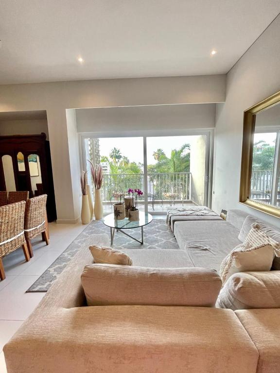 a living room with a couch and a table at New 2 bedroom rooftop condo in Nuevo Vallarta