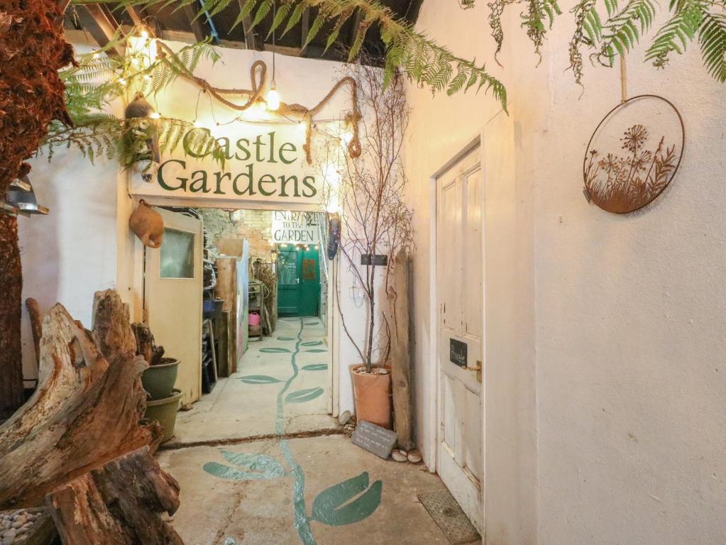 a shop with a sign that reads castle gardens at Castle Gardens Apartment in Beaumaris