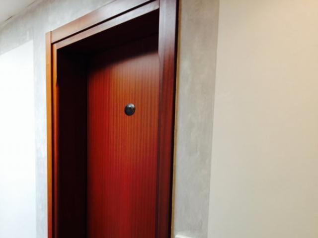 a red door in a room with a mirror at venice blu hotel in Mirano