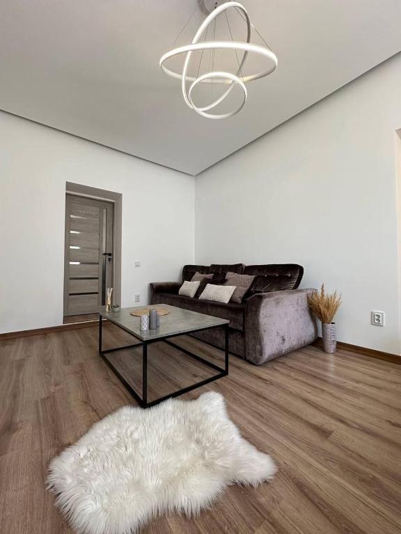 a living room with a couch and a table at Comfort Forum House in Lviv
