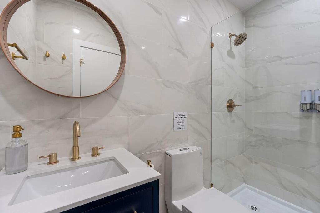 a bathroom with a sink and a toilet and a mirror at Spacious w/ 2BR 2Bath - Big Bear in Big Bear City