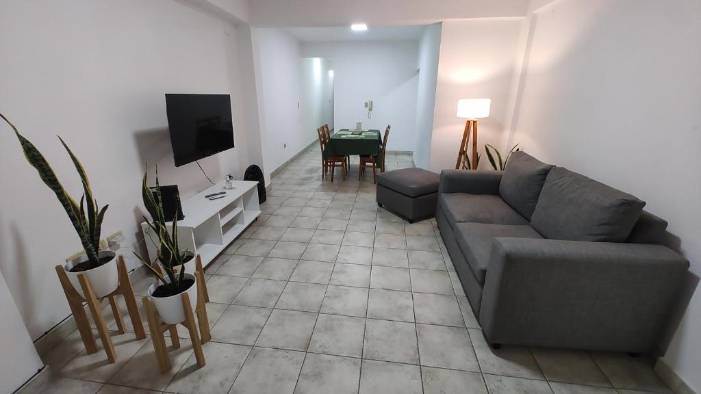 a living room with a couch and a table at Departamento La Merced in Santiago del Estero