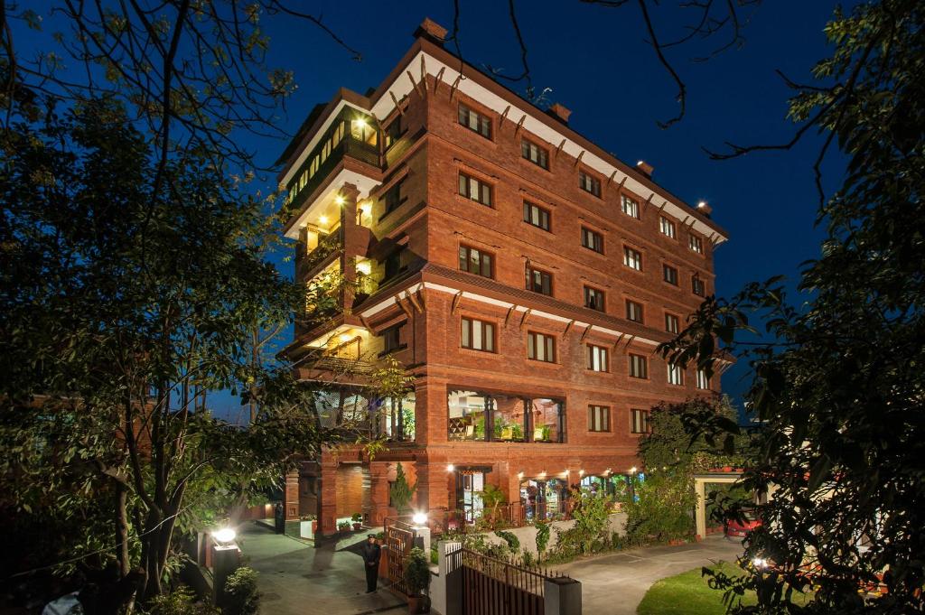 a large brick building at night at Traditional Comfort Boutique Hotel in Kathmandu