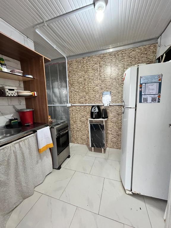 a kitchen with a refrigerator and a stove at Mirante Itajubá in Barra Velha