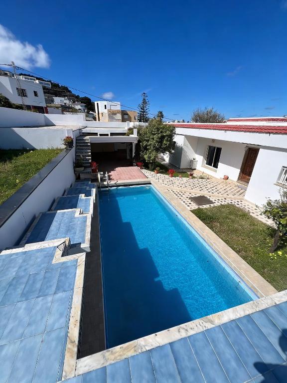 a swimming pool in the backyard of a house at Villa Horizon & Pool Bizerte in Bizerte