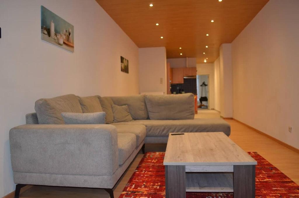 a living room with a couch and a coffee table at Cozy Apartment for 4 Steps from the Beach in Ostend