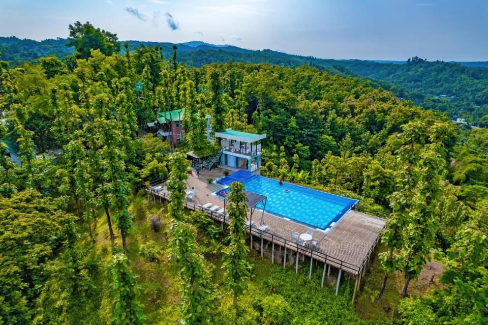 an aerial view of a house with a swimming pool at Green Peak Resorts in Baitarāni