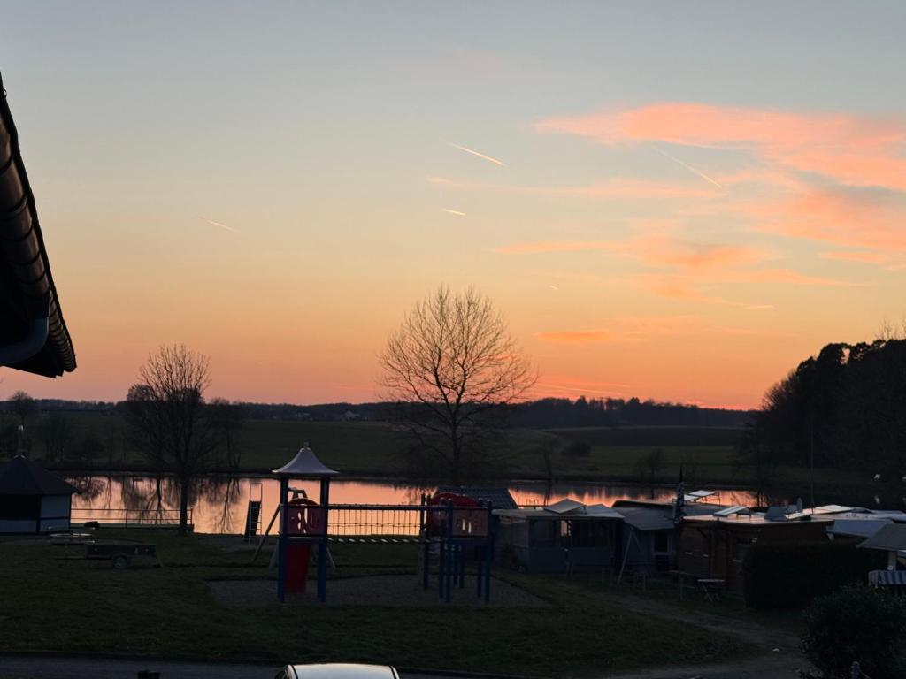 a view of a playground at sunset at Gaststätte Seehaus Maroth in Maroth