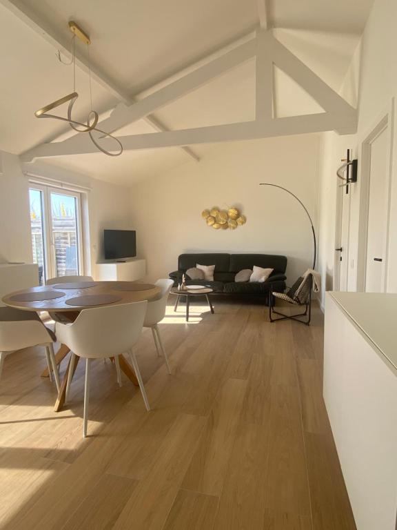 a living room with a table and a couch at Sea & Stay Bredene Zeewind 2 in Bredene