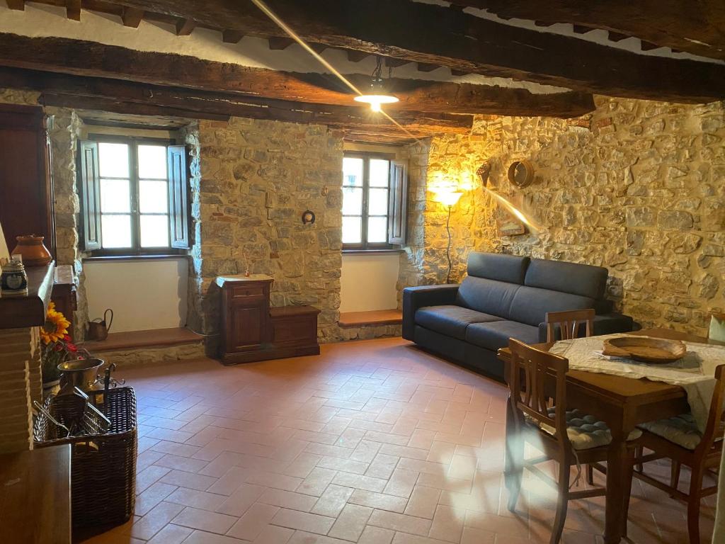 a living room with a couch and a table at Finestra sulla Val D'Orcia in Campiglia dʼOrcia