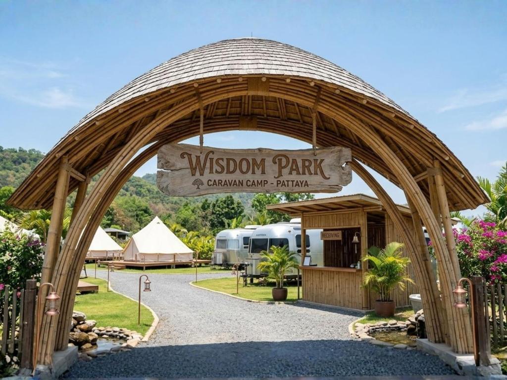 a entrance to a wislow park with a sign at Wisdom Park Caravan Camp Pattaya in Ban Khao Mai Kaeo