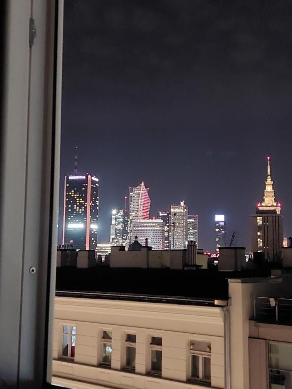a view of a city skyline at night at Pokoje gościnne na Lwowskiej in Warsaw