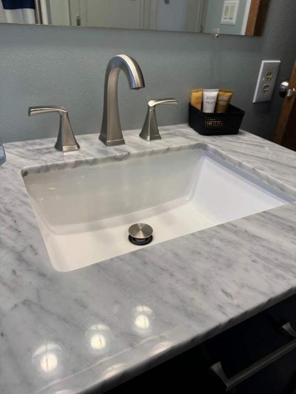 a white sink with two faucets on a counter at Lilly Pad Landing in Hazelhurst