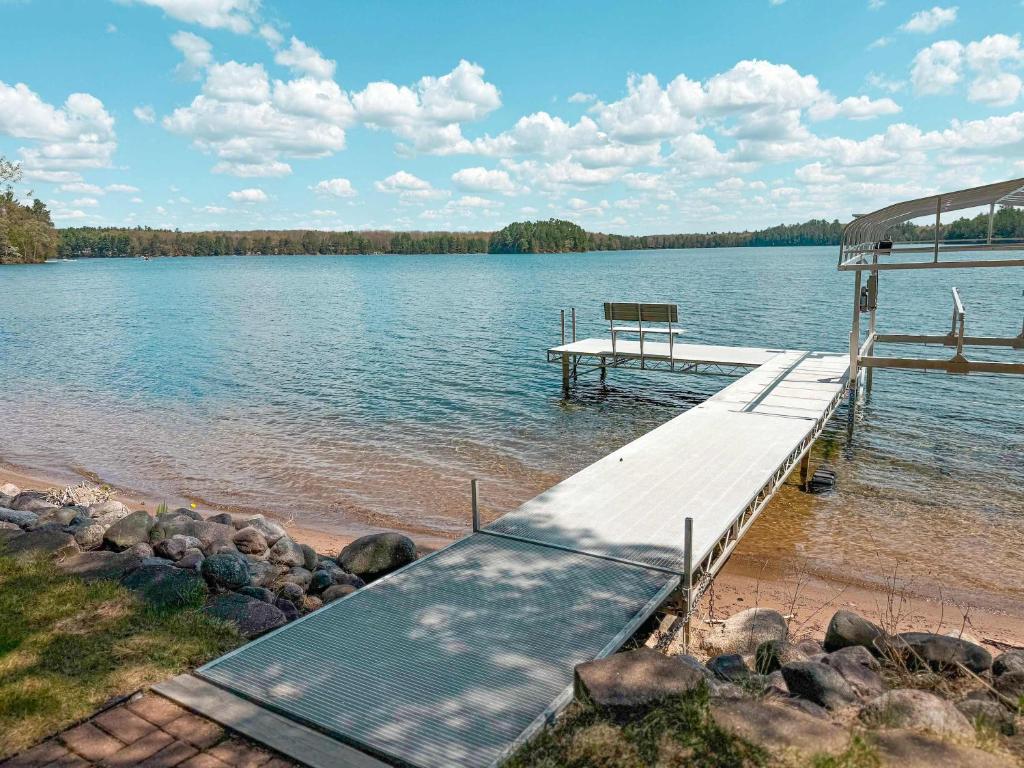 a dock on a lake with a bench on it at Katherine Lake Lodge in Hazelhurst
