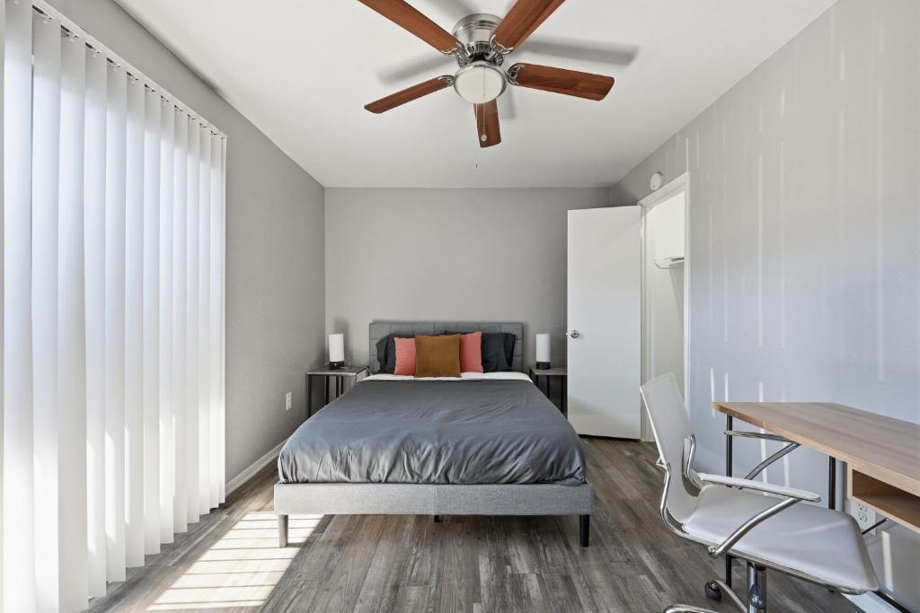 a bedroom with a bed and a ceiling fan at Great 1BR Mid-Term Apartment in Denton